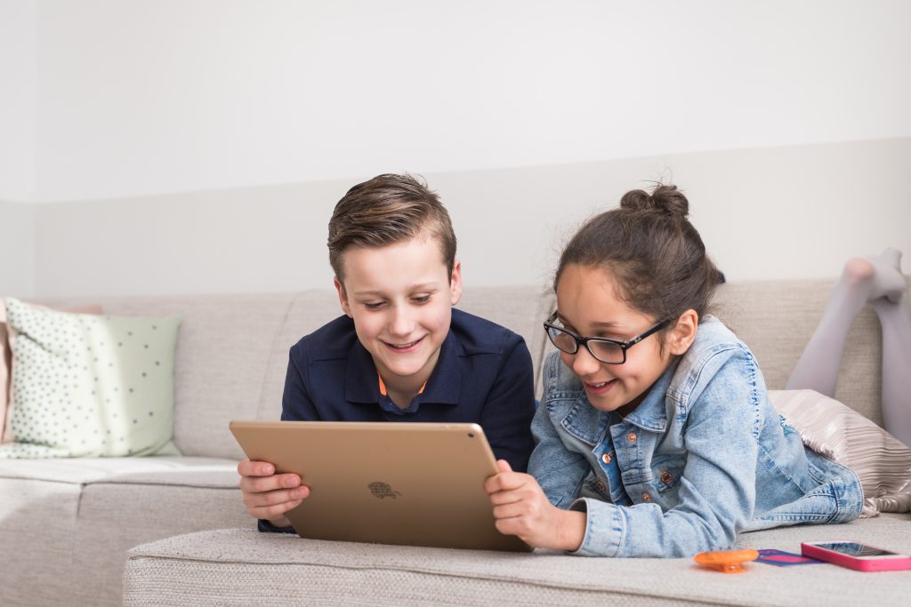 Boy and girl looking at a tablet together, with Mytimingcards time cards