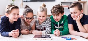 Five children looking at a tablet together