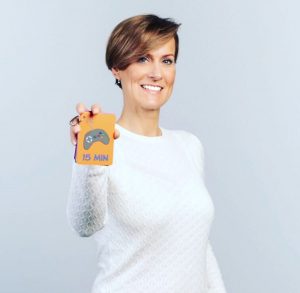 Lisette van der Kuij, inventor of Mytimingcards, holding a time card